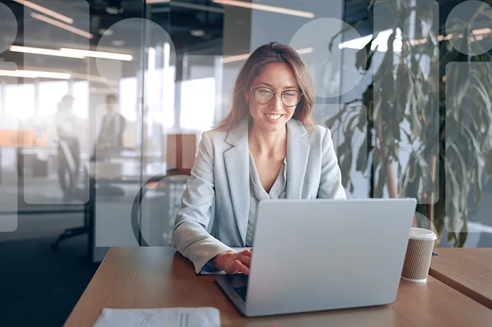 Woman sitting at laptop in isolved office