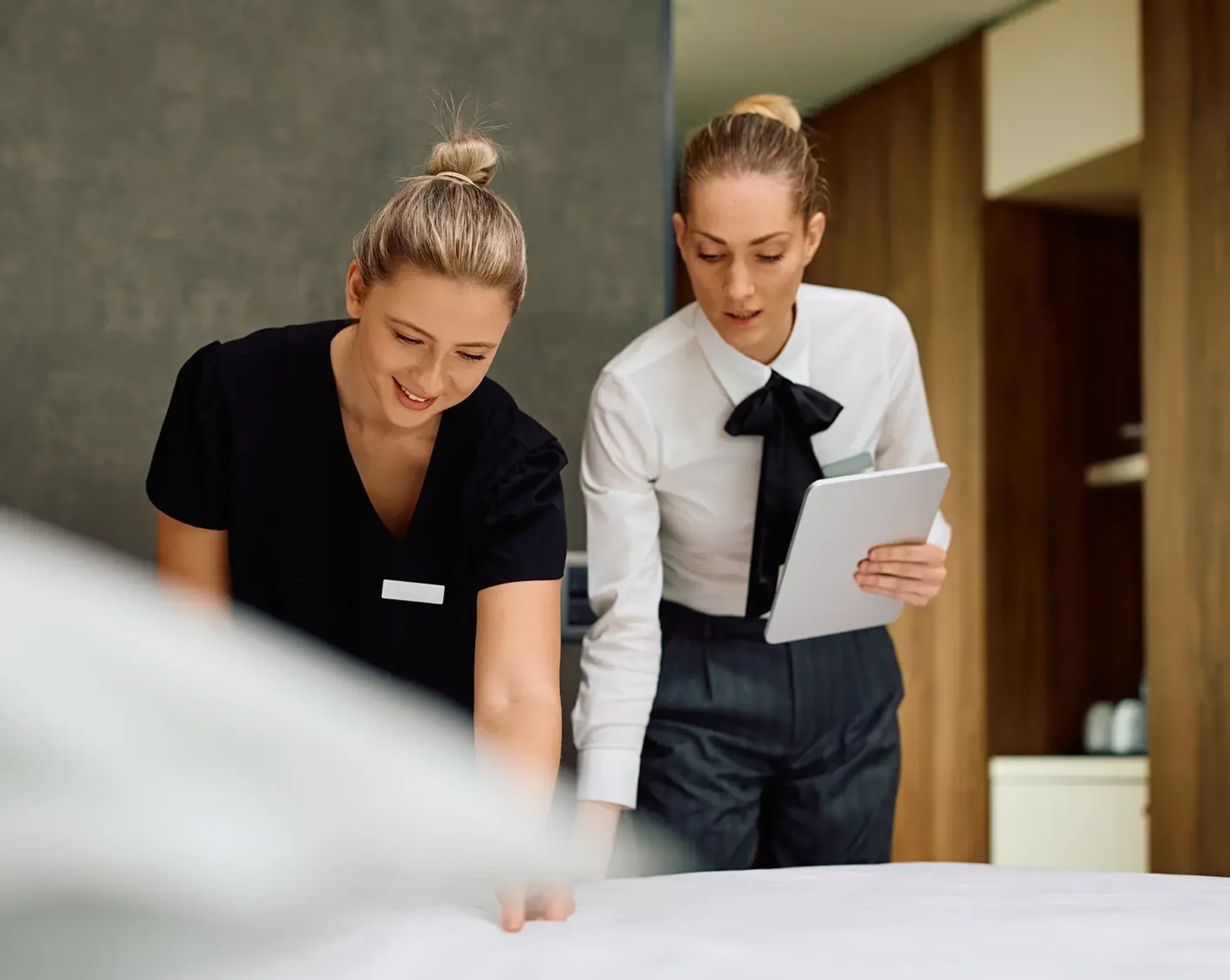 hospitality administrator inspecting bed