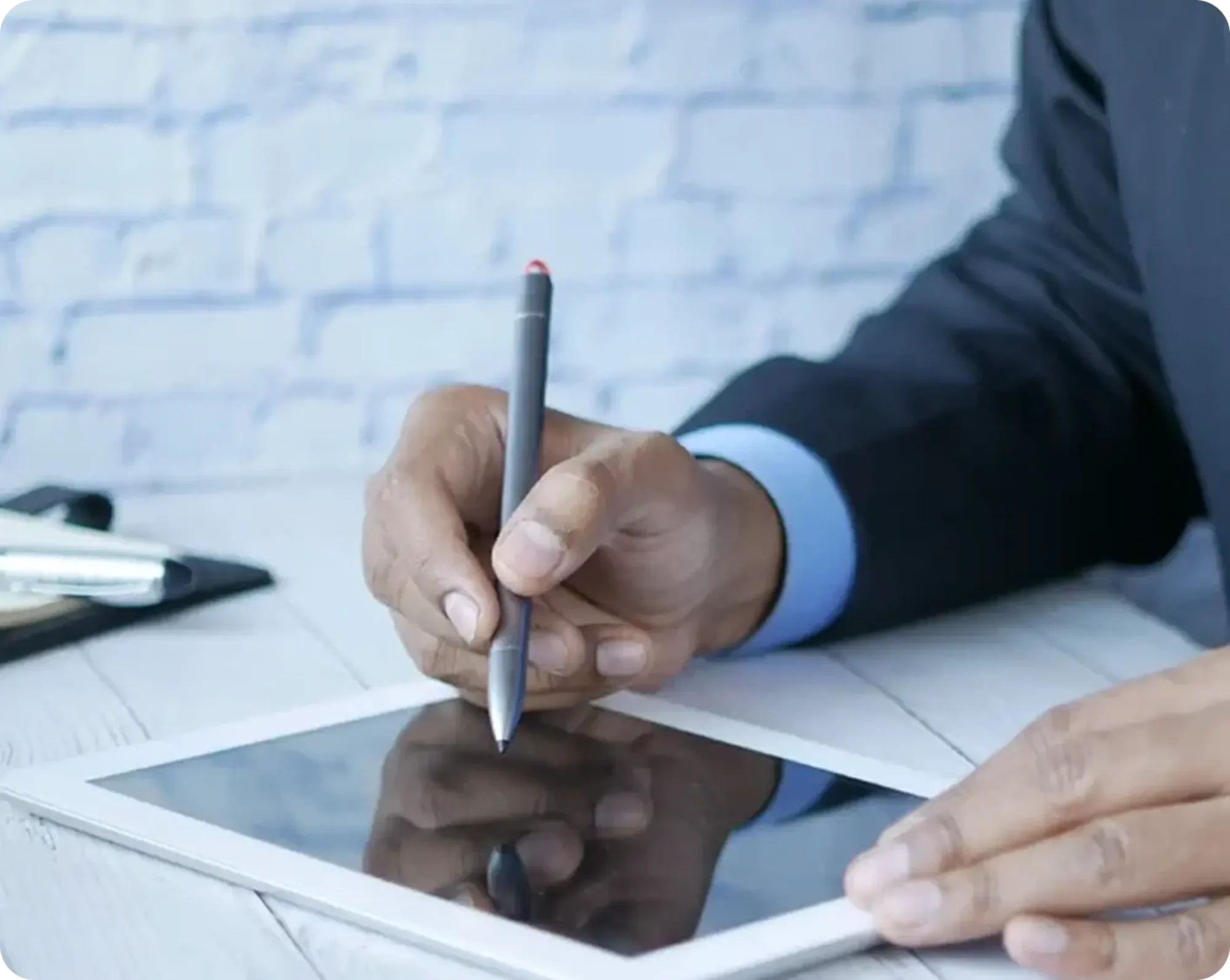 man writing on table and staying compliant