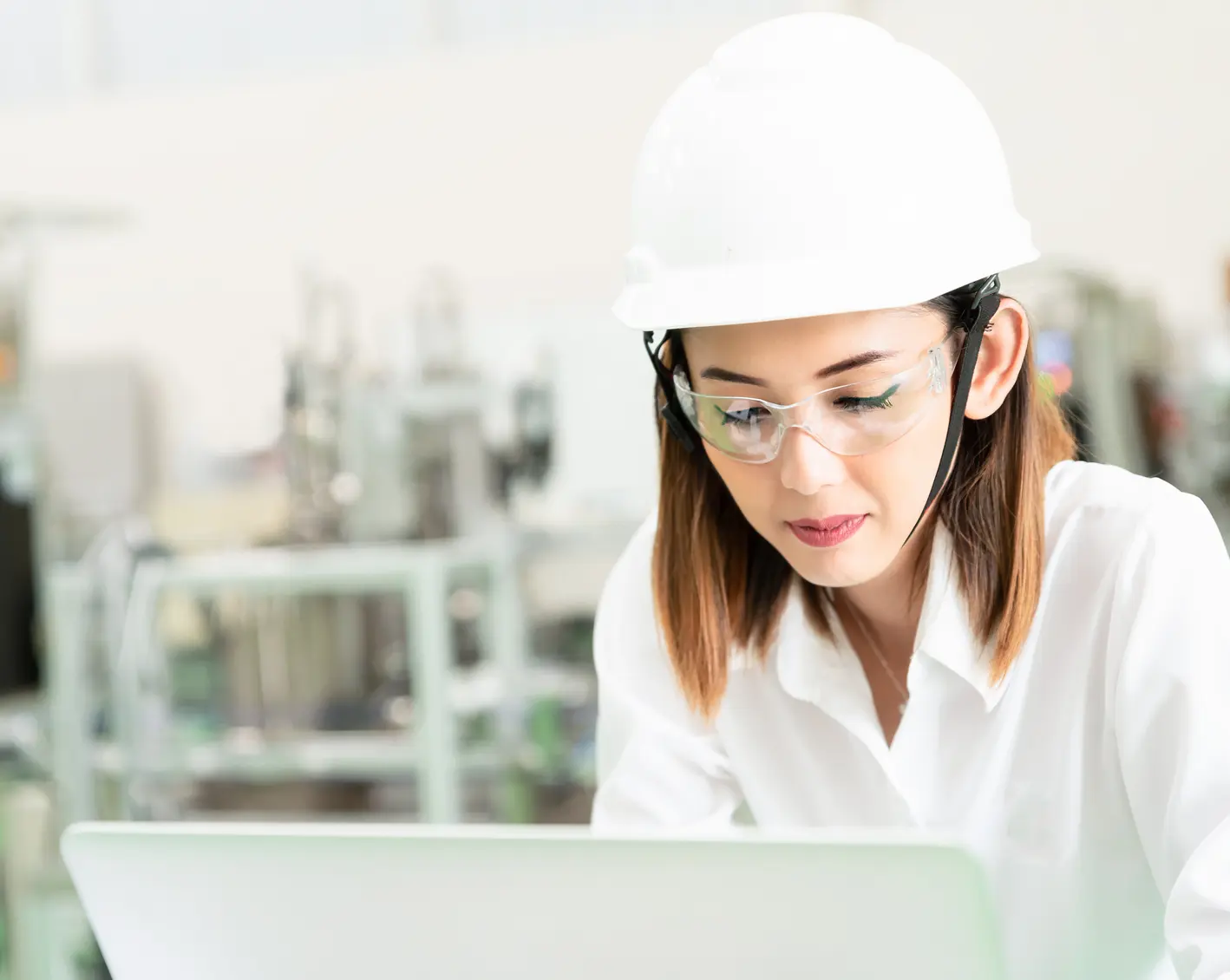construction employee looking over notes on computer