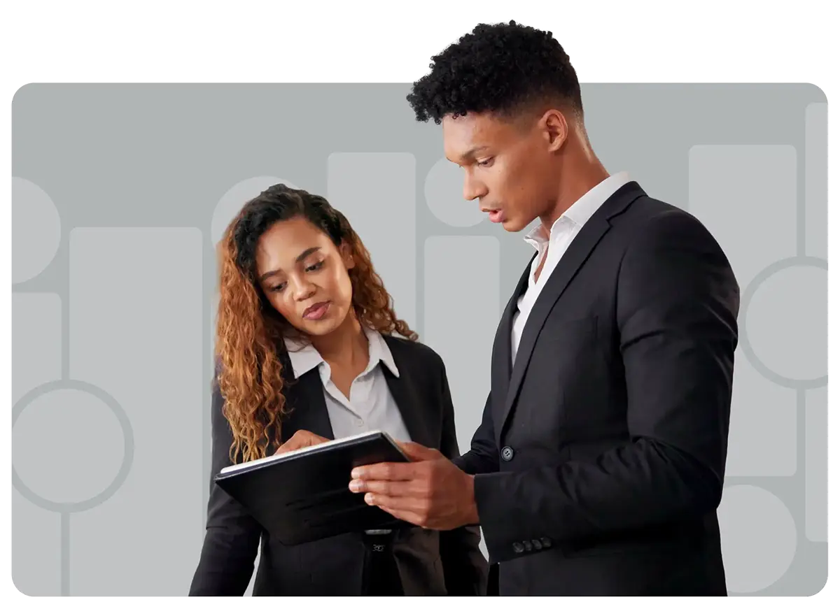 a couple of hotel employees making notes on tablet