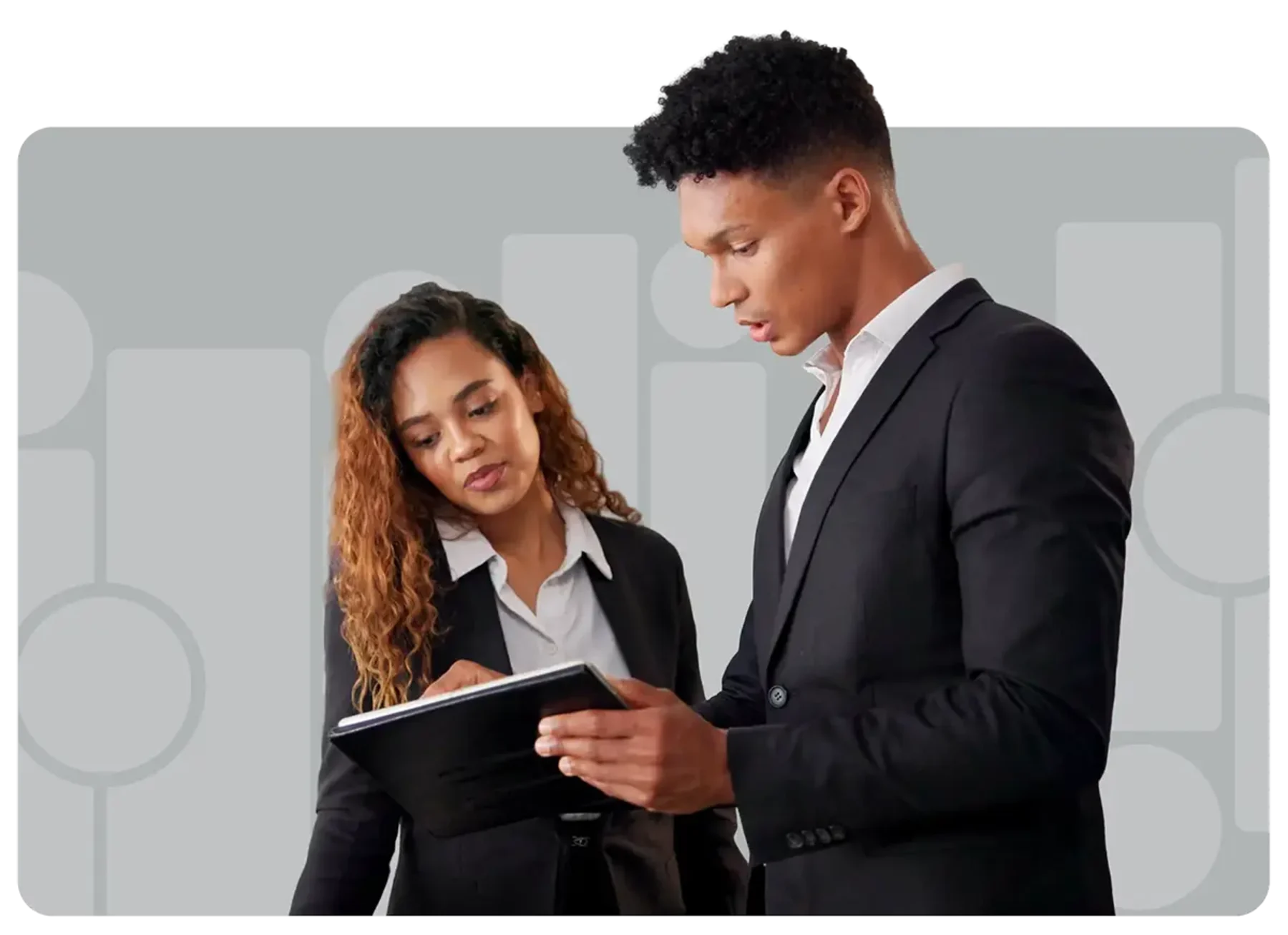 a couple of hotel employees making notes on tablet