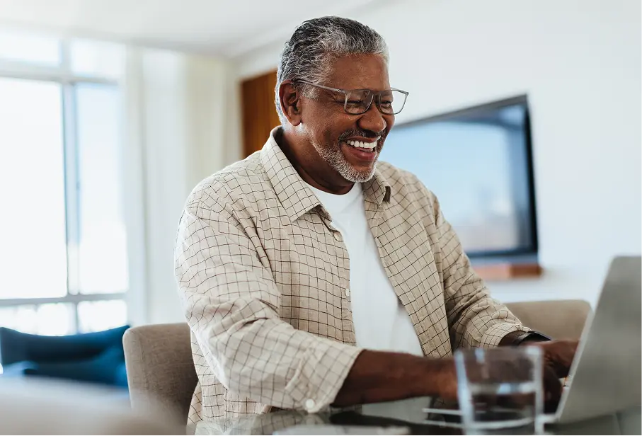 man at home on computer looking up financial statements