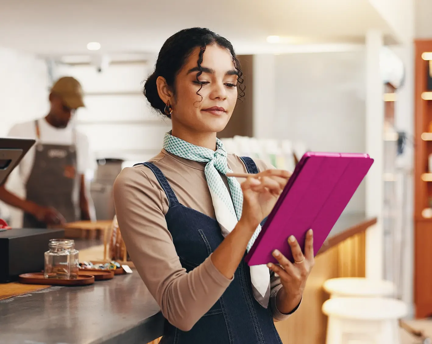 woman employee looking over schedule on tablet