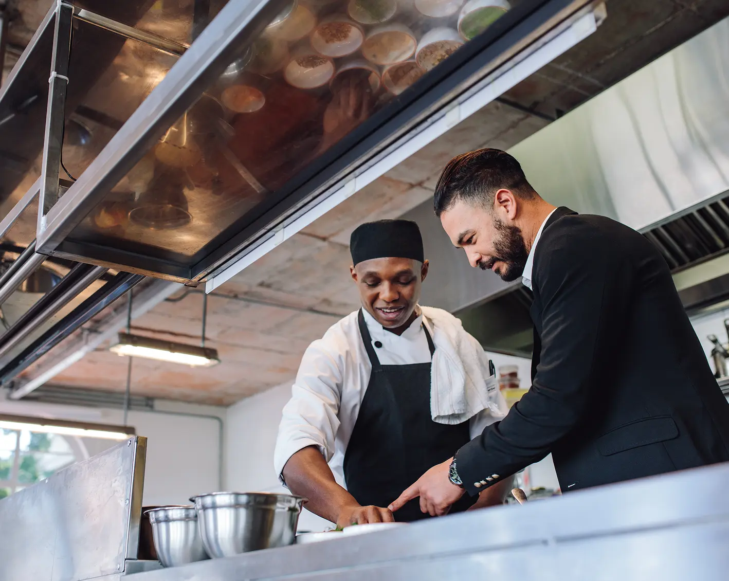 owner inspecting kitchen of his restaurant