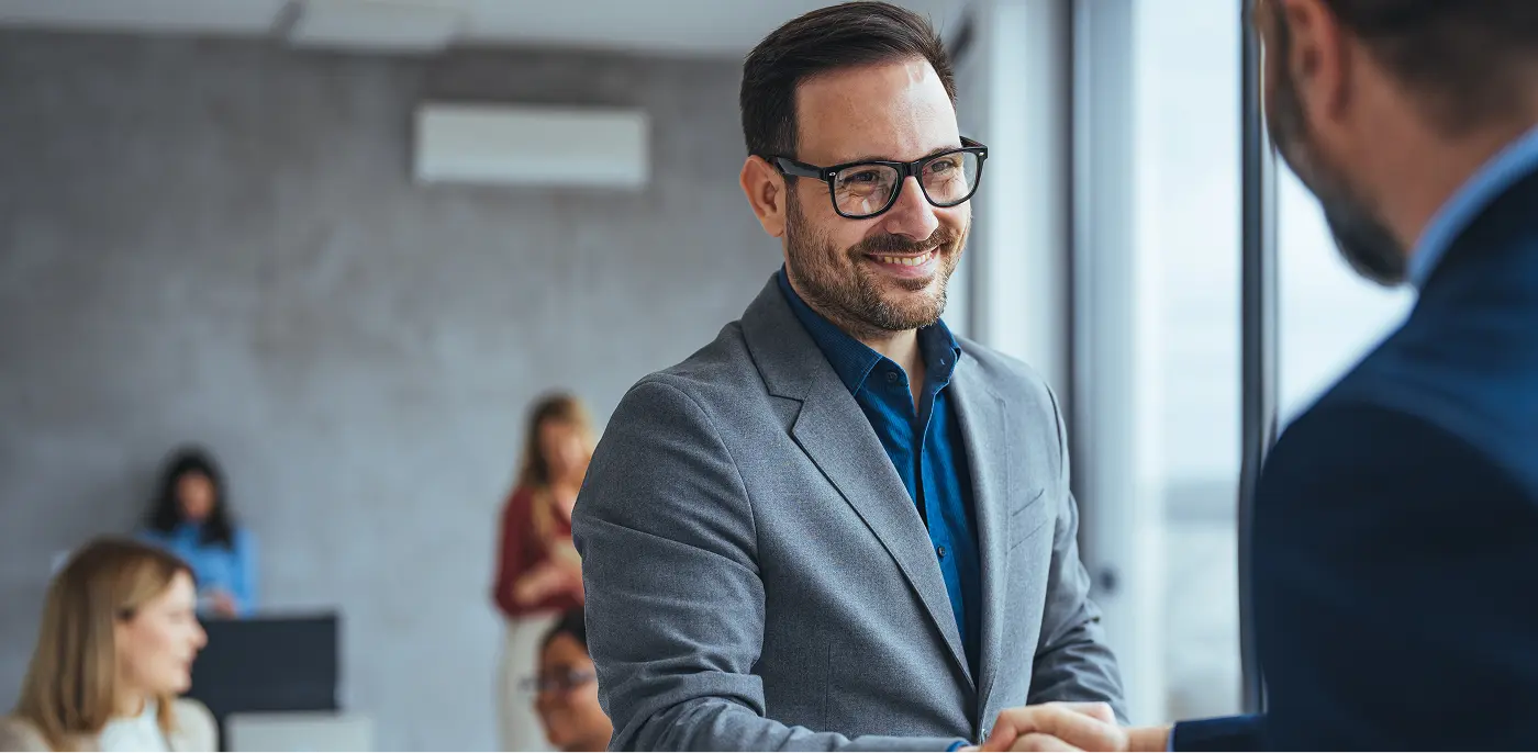 businessman shaking hands on deal for payroll
