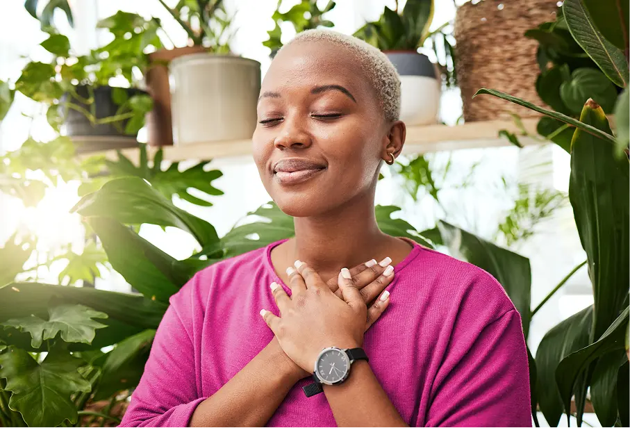 peaceful woman employee with green plants in background
