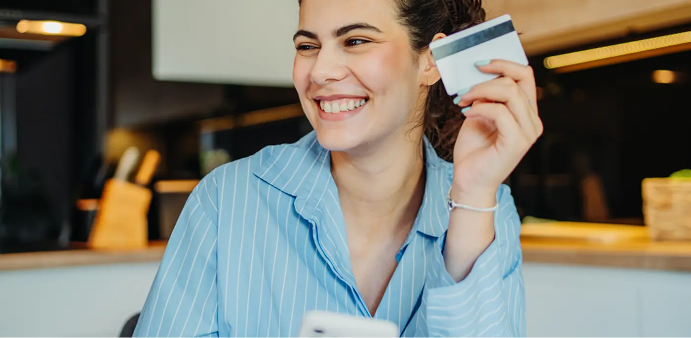 woman happy with spending card in her hand