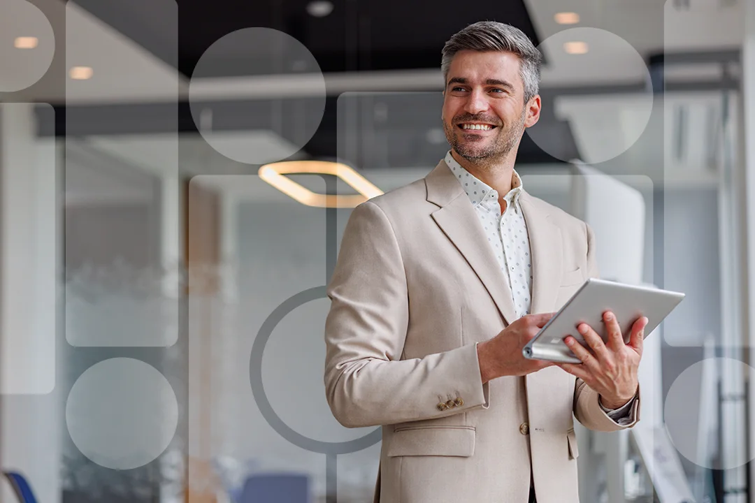 Smiling man holding a tablet