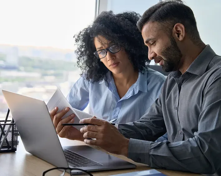 owners of mid-sized company looking over notes