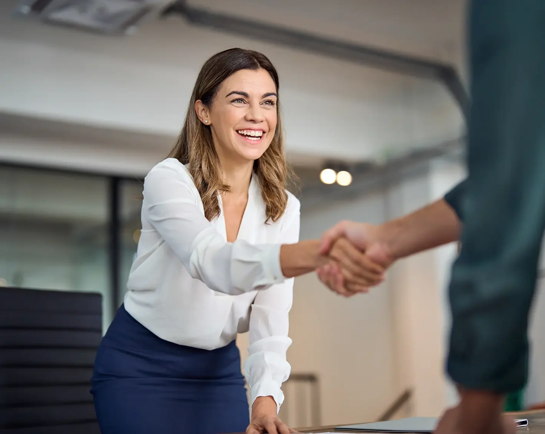 hr manager shaking hands with new employee