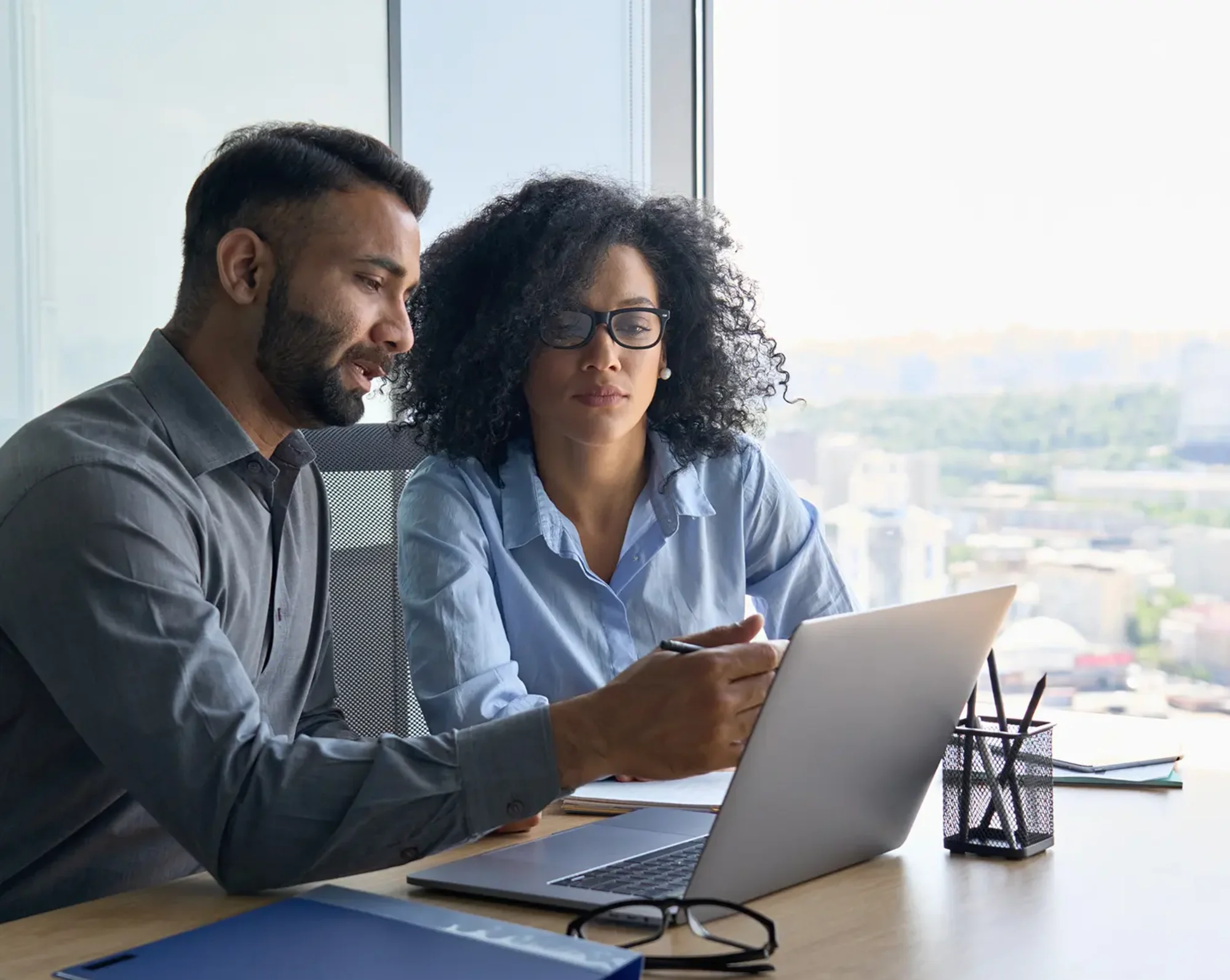 professionals looking over business plan on computer