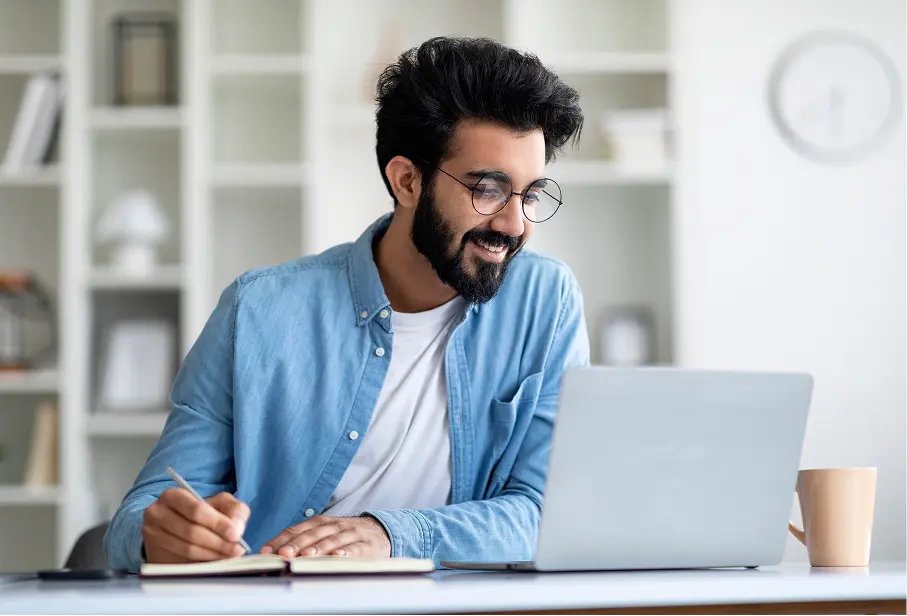 employee taking notes from computer