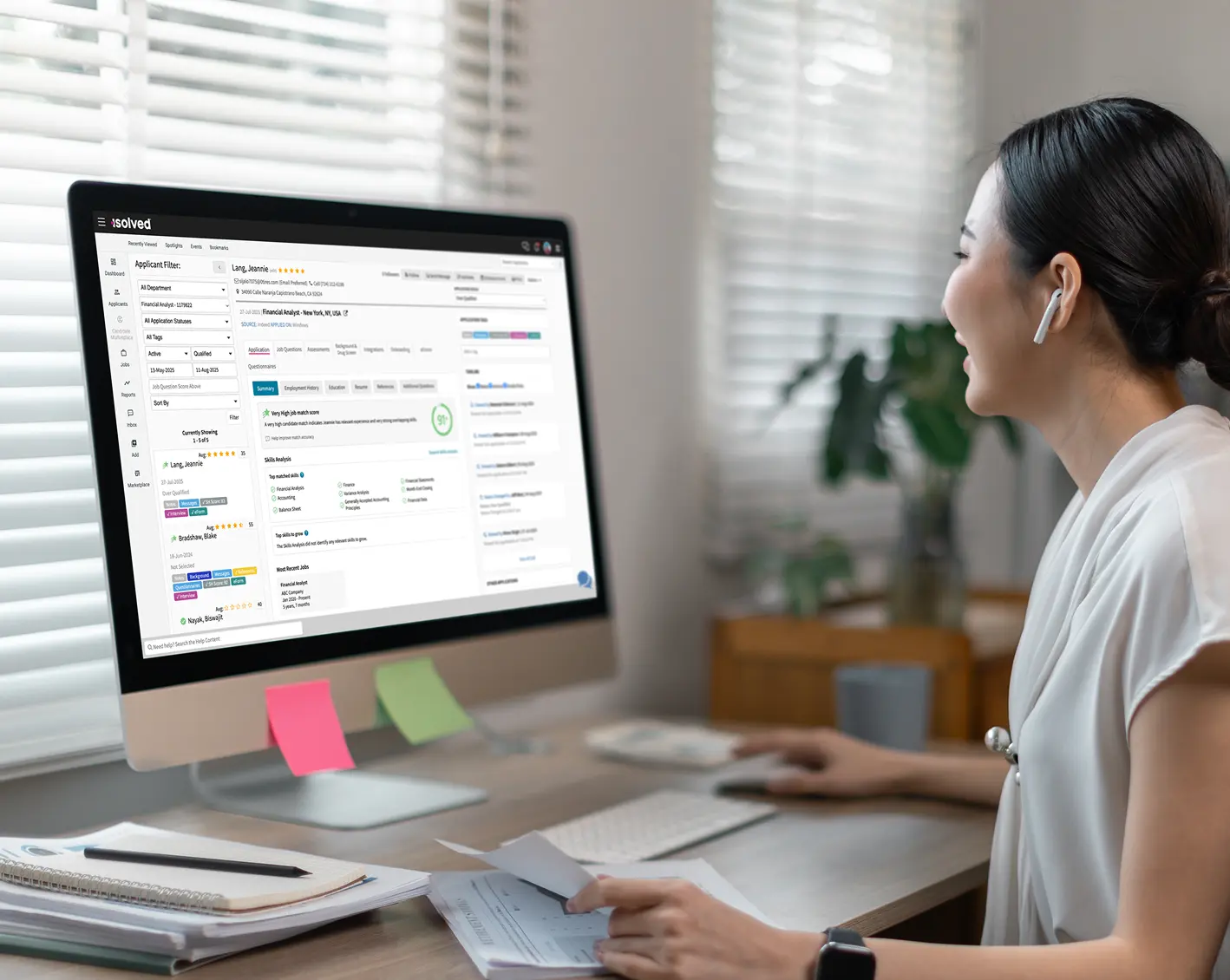 woman looking at computer screen with workforce management tools