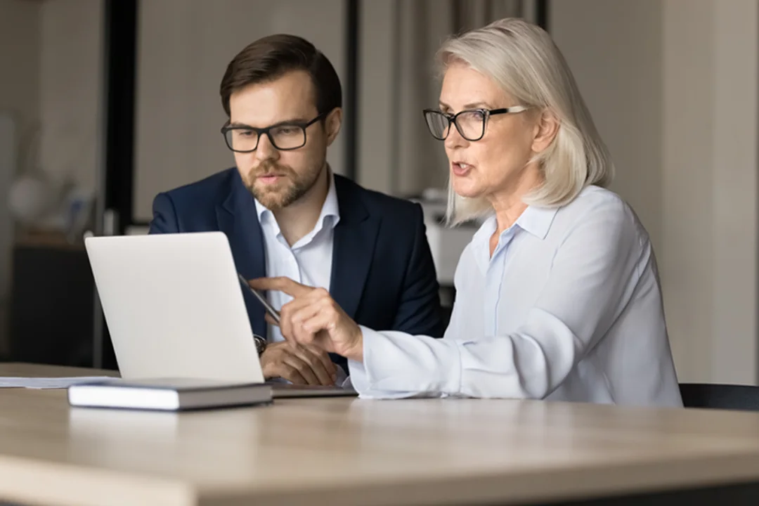 Two people looking at a screen during a meeting 