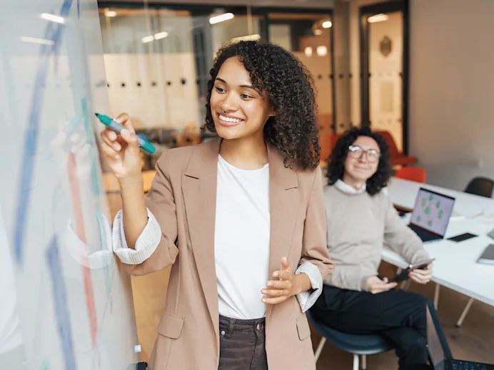 Woman writing on a whiteboard