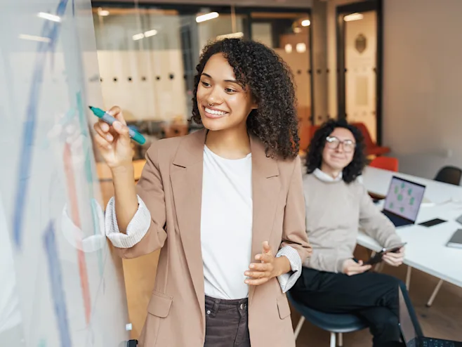 Woman writing on a whiteboard