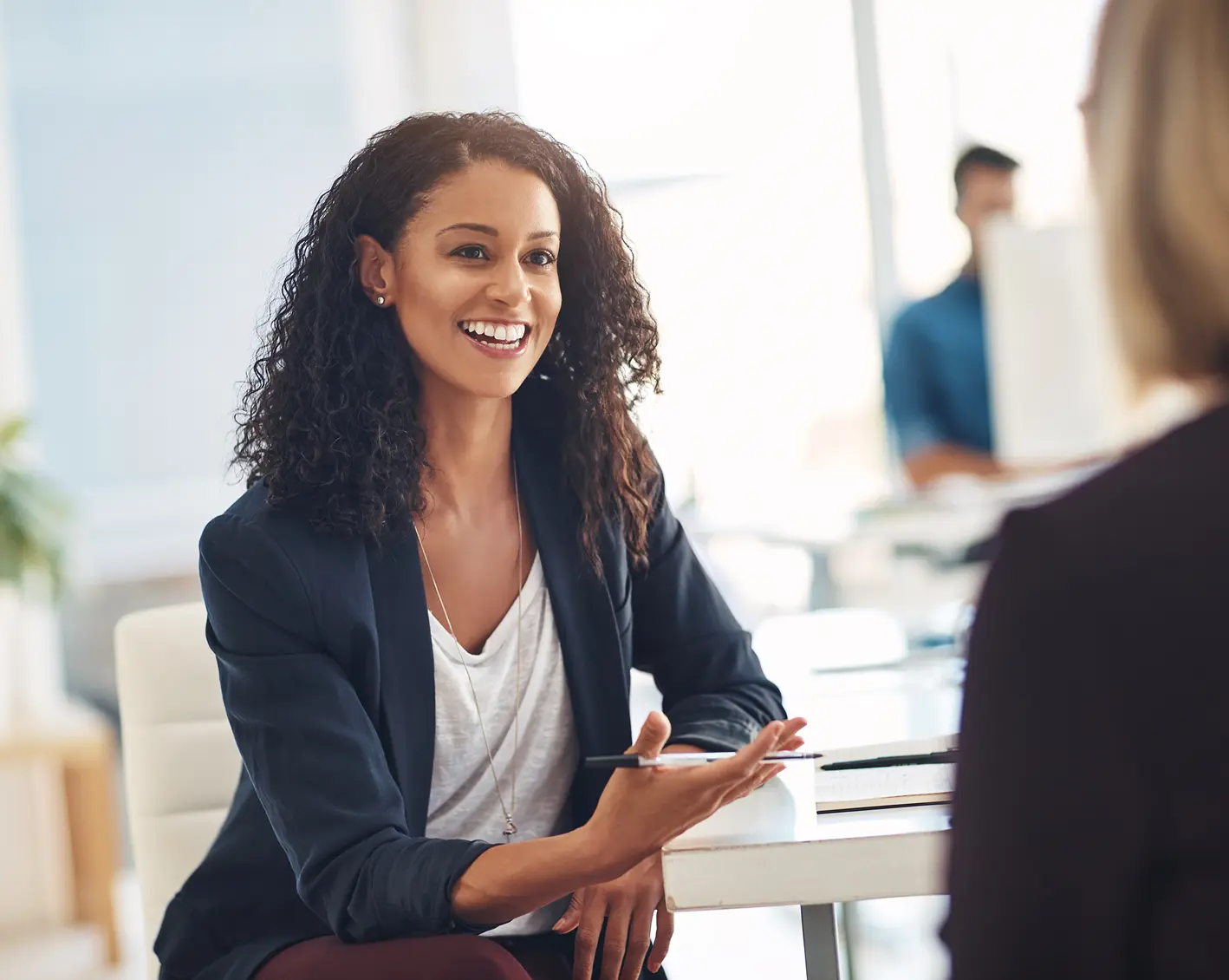 smiling business woman discussing with another business woman