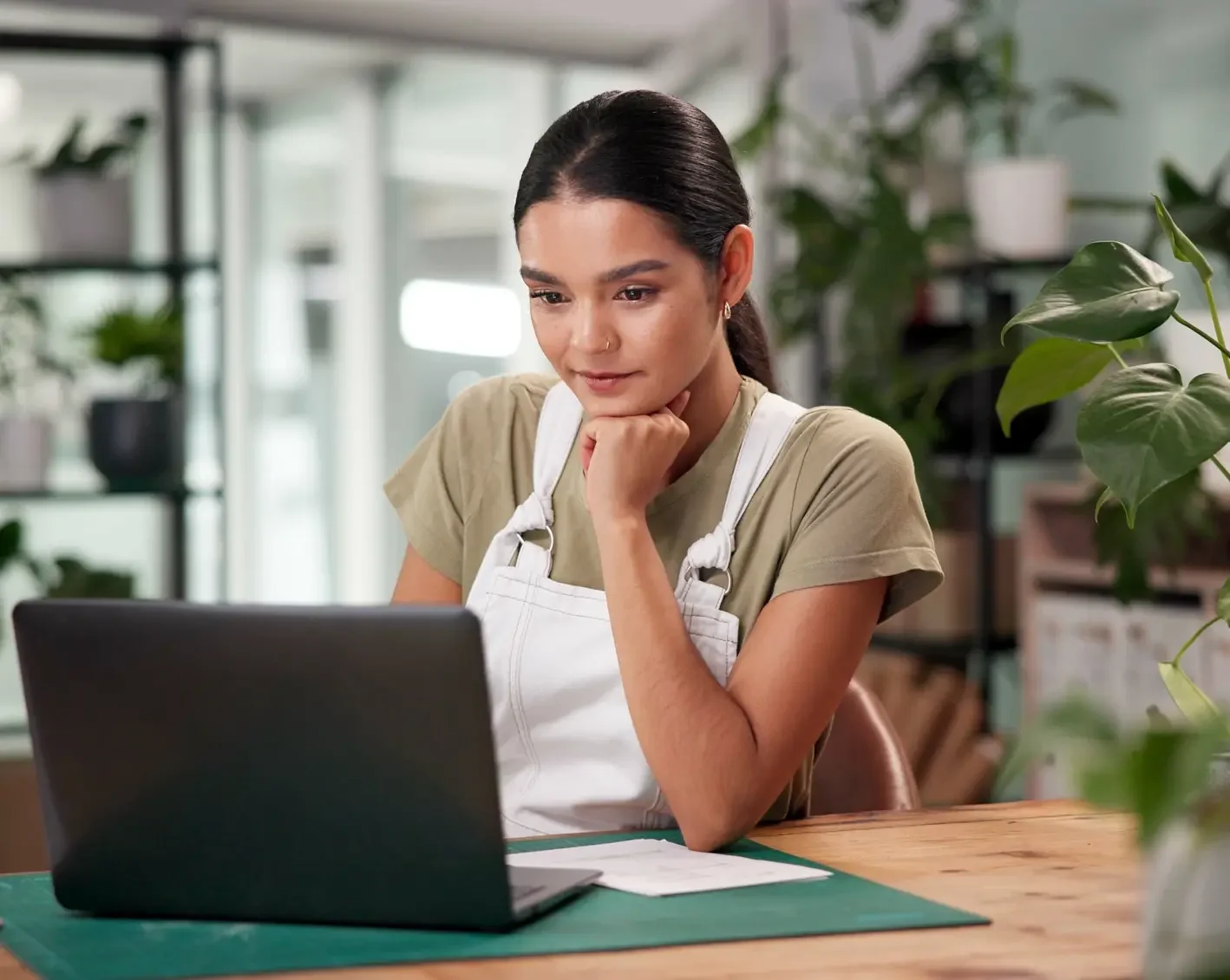 small business owner managing payroll on laptop