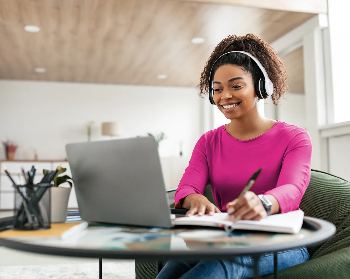 employee with headphones working on project on computer