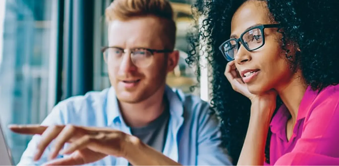 employees looking and computer screen with hr services