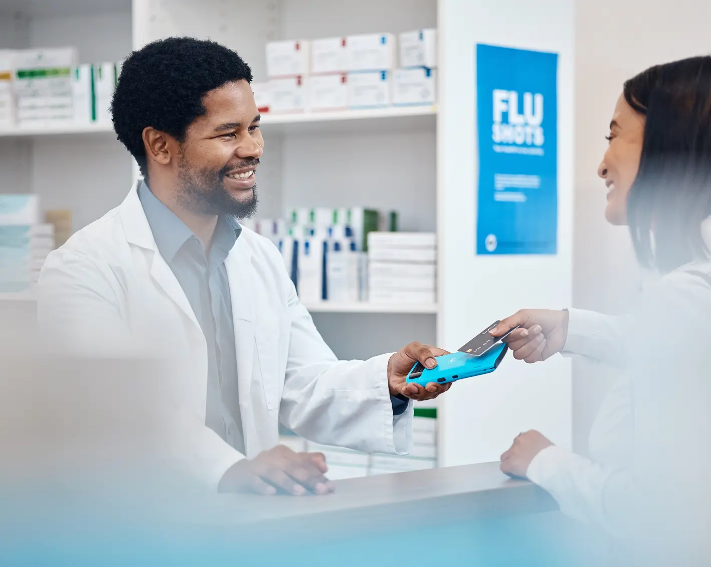 pharmacist helping lady using fsa card