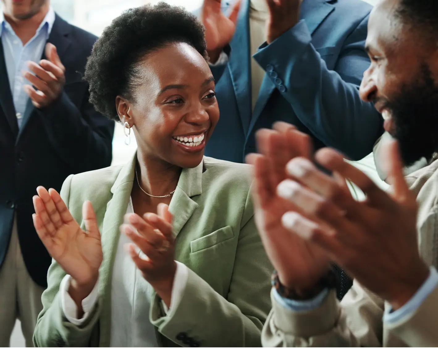 group of people smiling and clapping