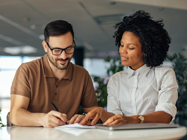 A man and woman looking at paperwork