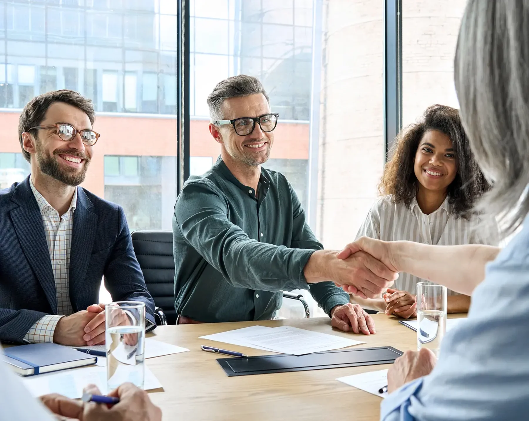 company owner shaking hands with payroll service provider admin