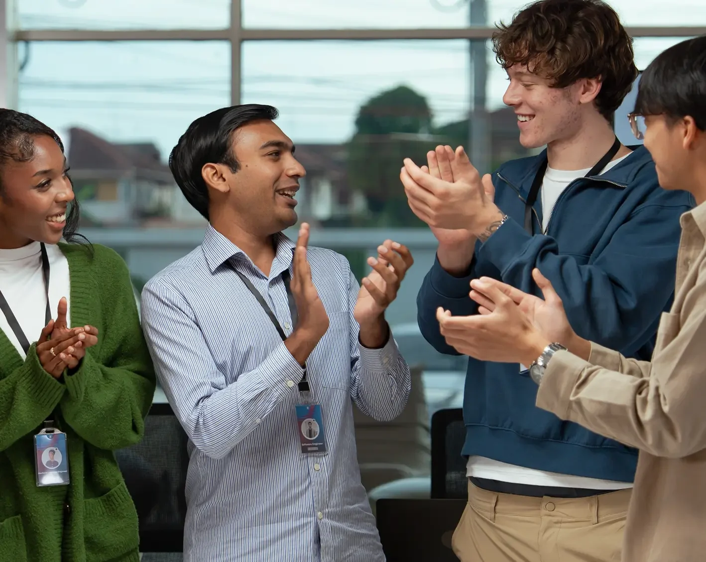 group of employees clapping and smiling