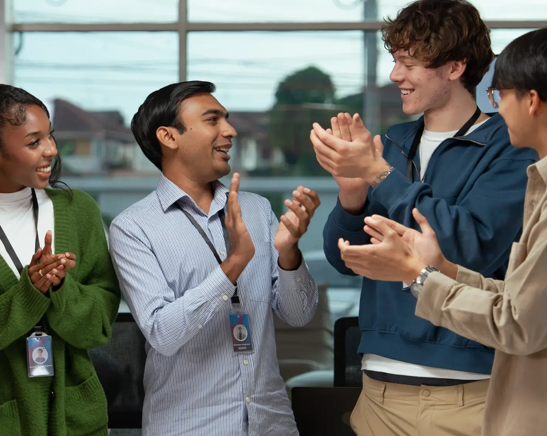 group of employees clapping and smiling