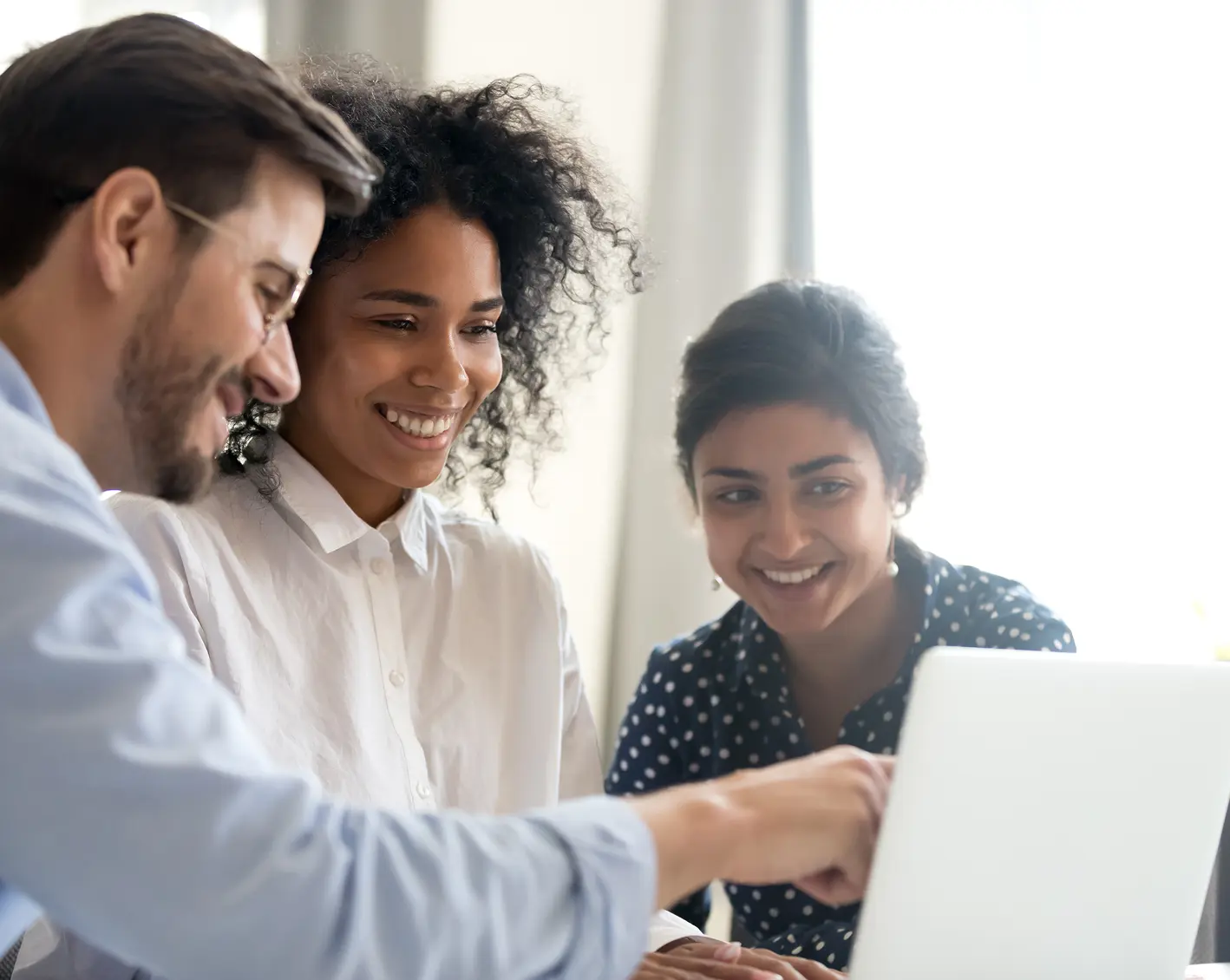 hr team looking at computer screen with new employee