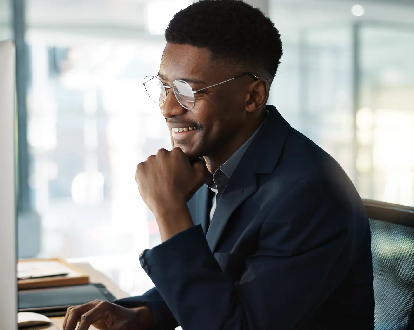 man on computer excited about hcm