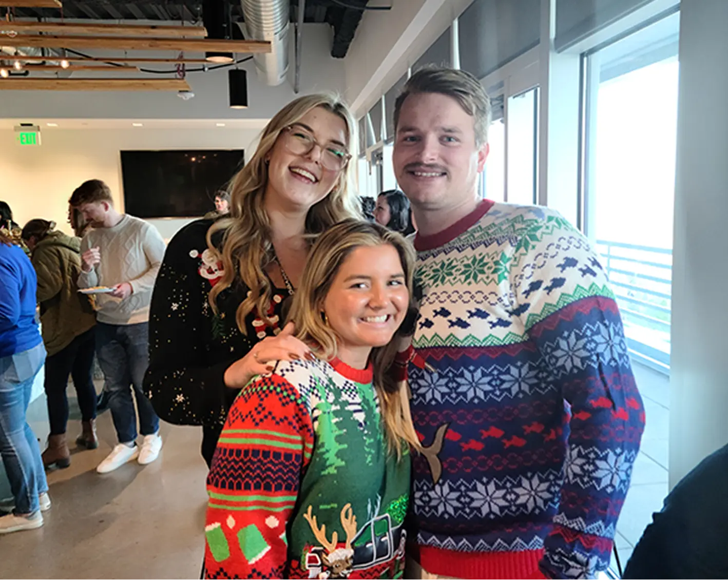 isolved employees with christmas sweaters