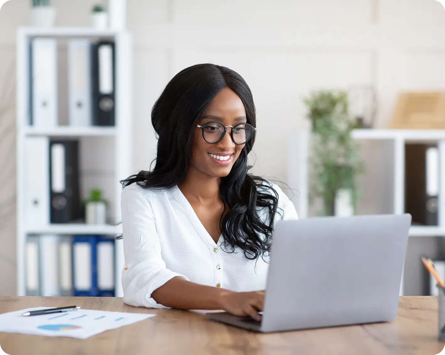 smiling financial employee looking at computer