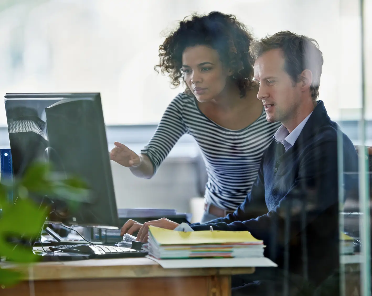 hr looking at computer discussing payroll and tax management