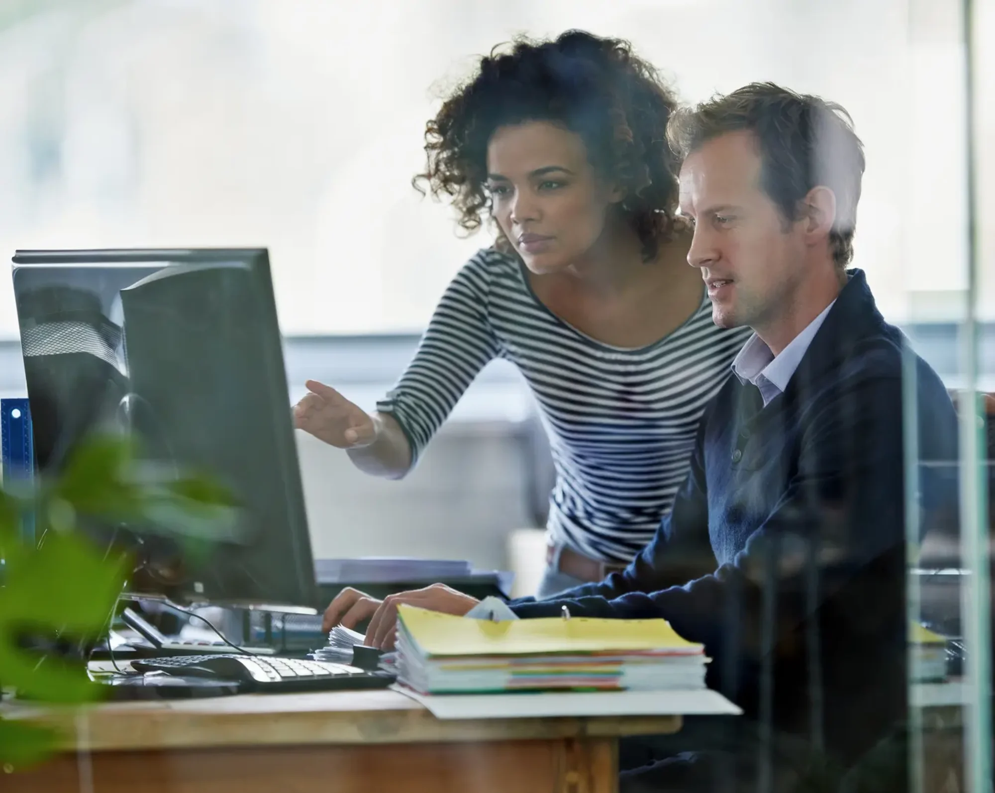 hr looking at computer discussing payroll and tax management