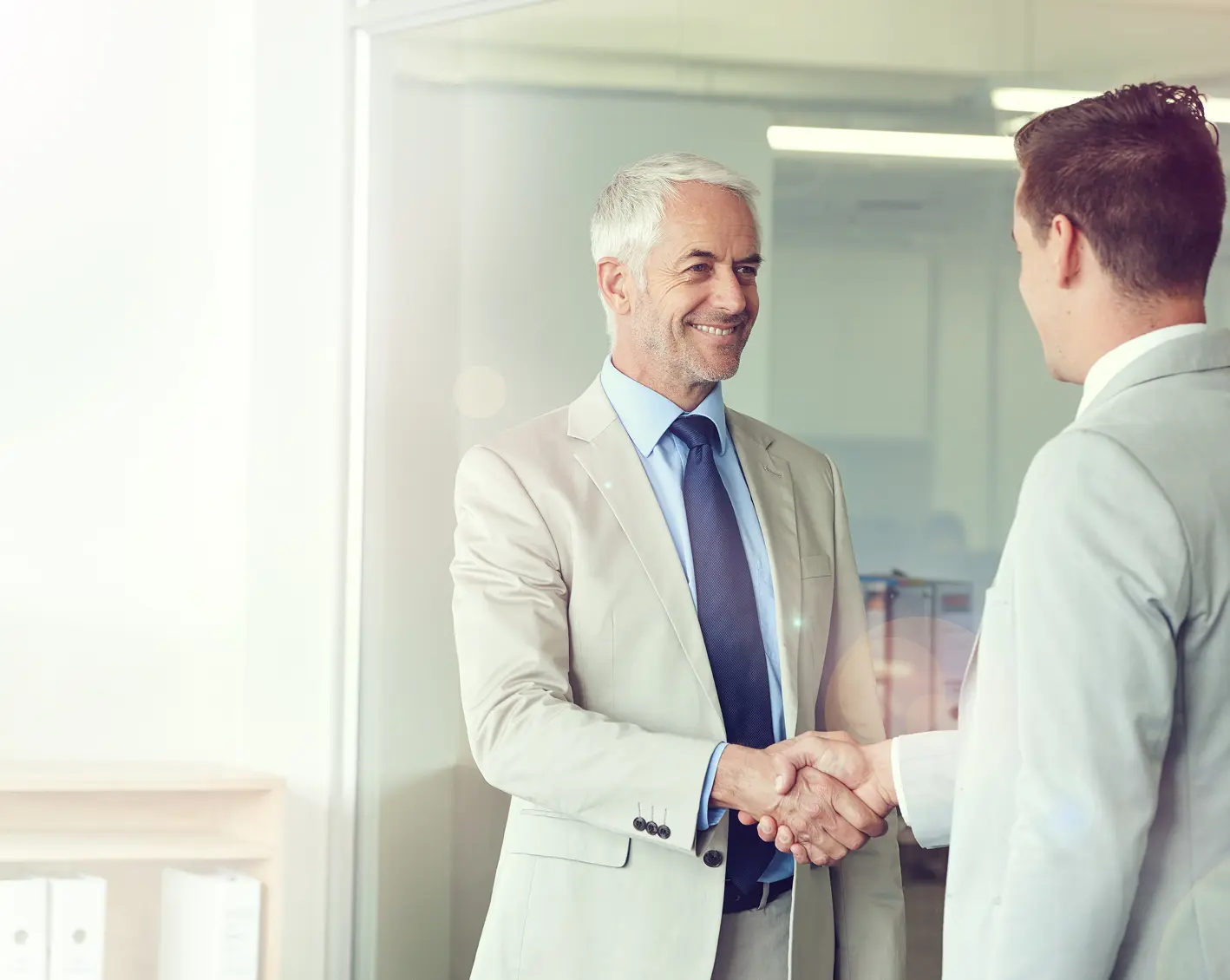 business owner shakes hands with new hire