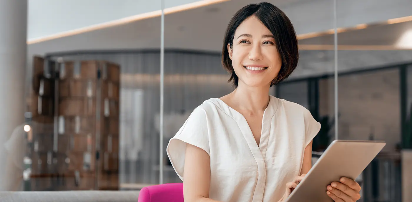smiling woman looking over isolved 401k plan