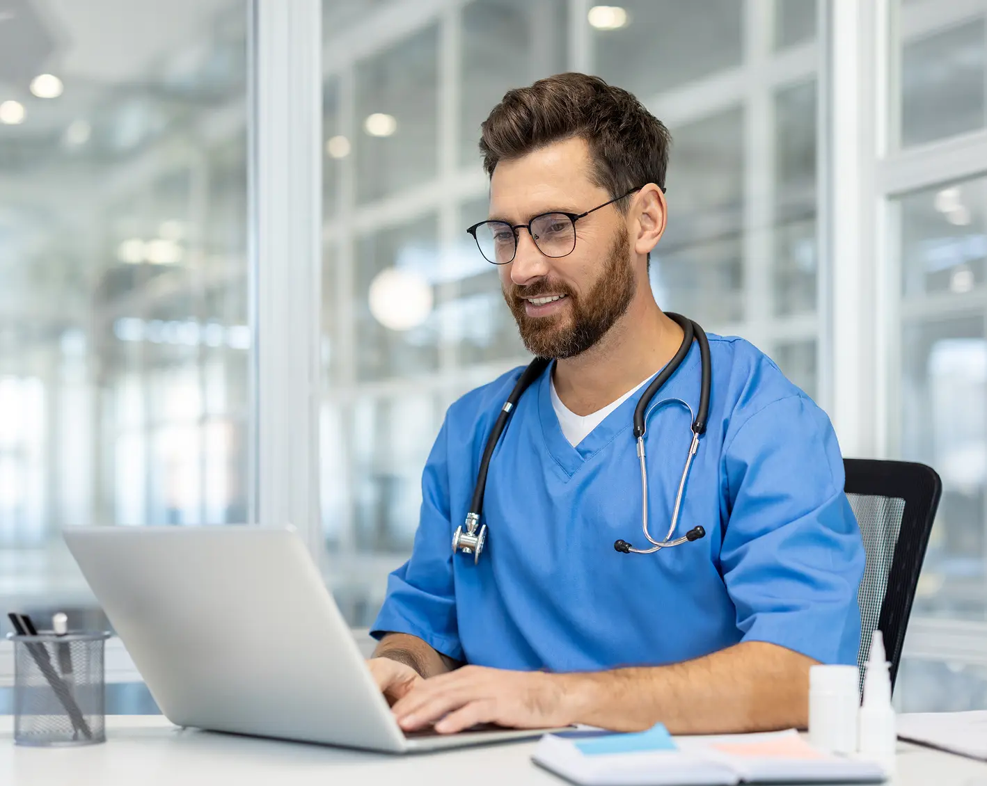 hospital employee looking up notes on computer