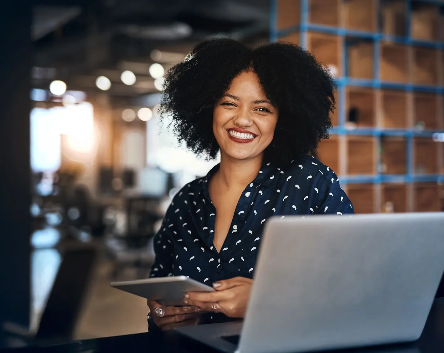 smiling restaurant employee at the front desk