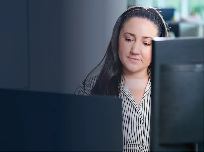 Woman looking at a desktop computer