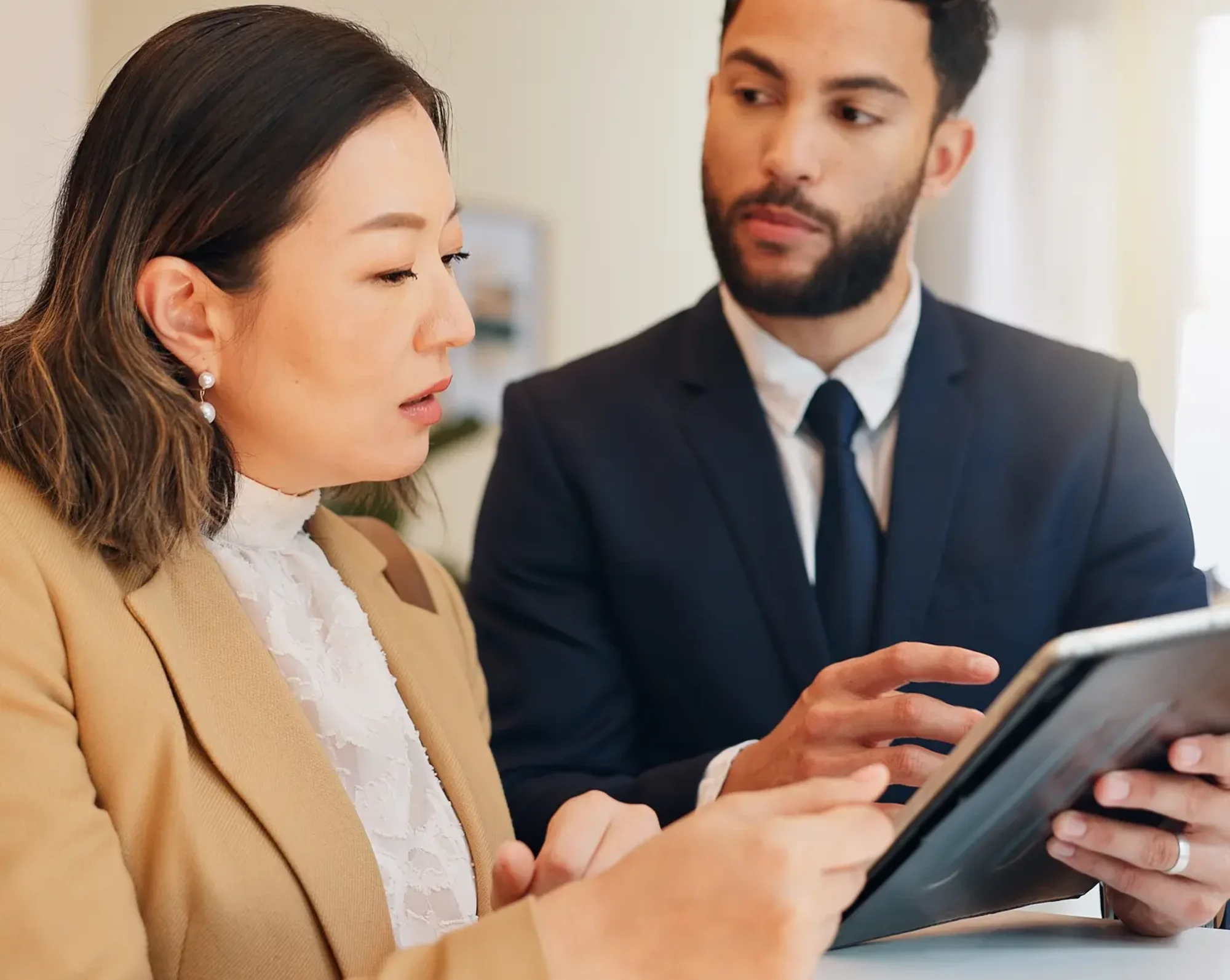 hotel workers looking over information on tablet