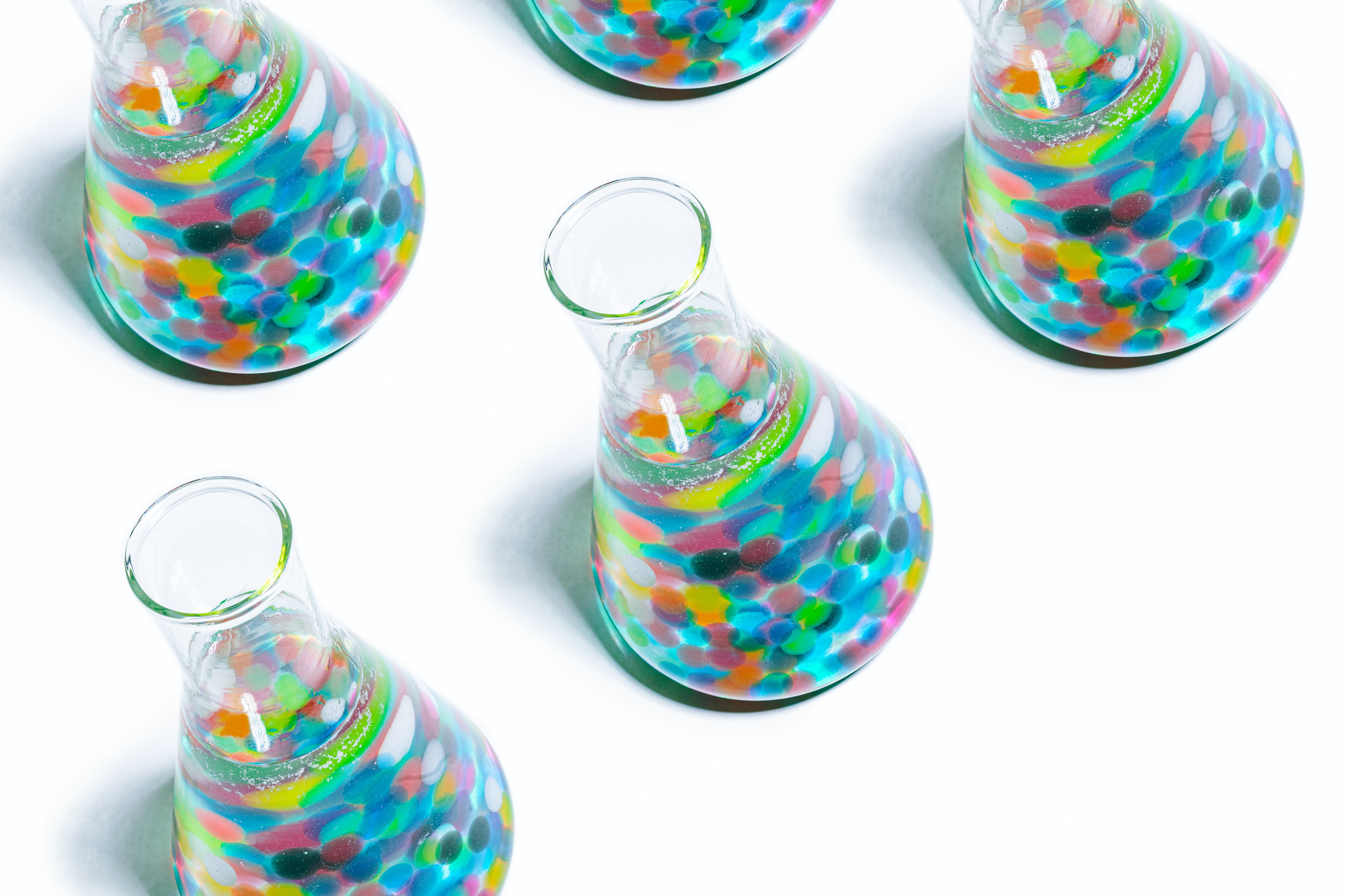 Colourful flasks on white background