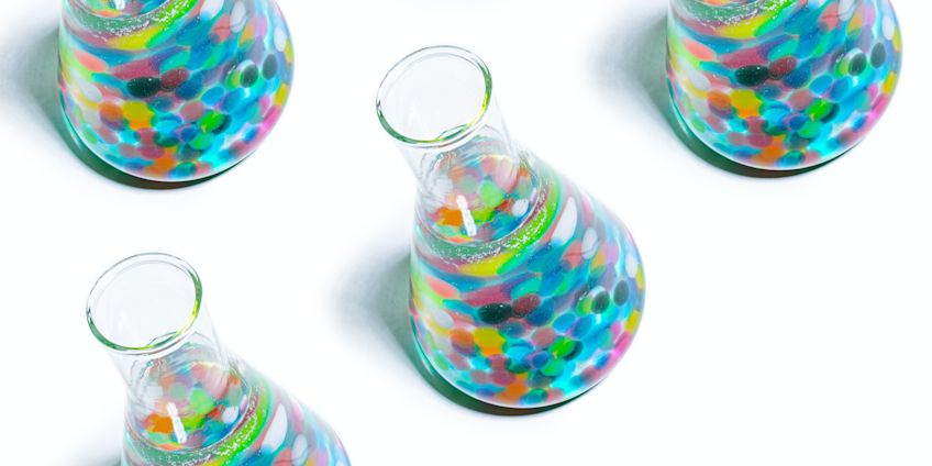 Colourful flasks on white background