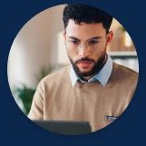 Portrait of a district transportation coordinator looking at a laptop