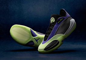 Two Jordan Triangle Q54 basketball shoes displayed against a dark blue background. The front shoe shows the lateral profile with a black mesh upper, deep purple overlays and Jumpman branding, and a volt green midsole with a neon green basketball logo on the tongue. The rear shoe is tilted to display the volt green outsole with a chevron-pattern traction design and purple Triangle accent.