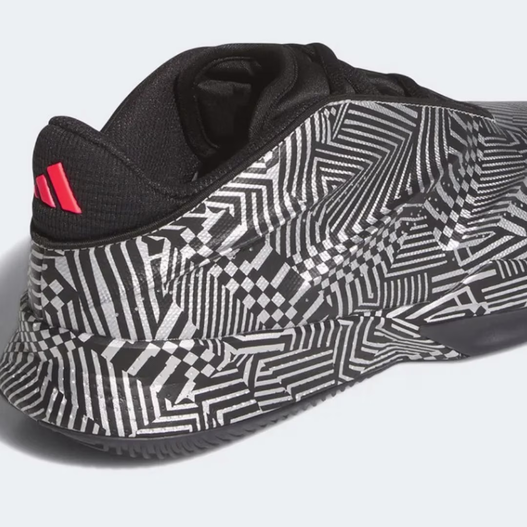 The adidas Crazy Energy+ displays a striking black knit upper with red Three Stripes branding on the heel counter, paired with an eye-catching geometric white and black pattern on the midsole and outsole. This rear three-quarter view showcases the shoe's retro-futuristic aesthetic, comfortable knit construction, and innovative LIGHTSTRIKE Pro cushioning technology designed for responsive basketball performance and modern street style.
