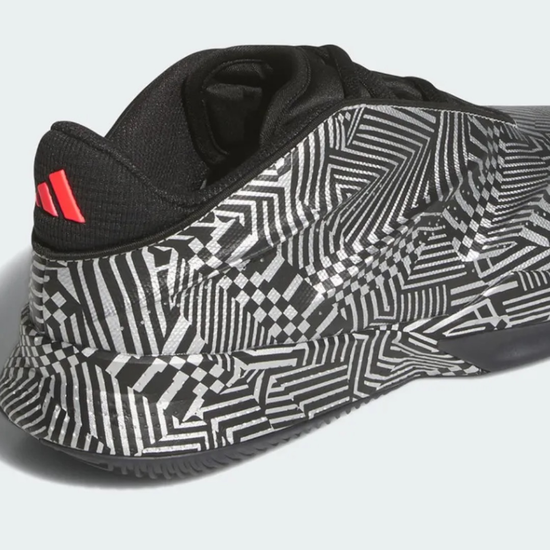 The adidas Crazy Energy+ displays a striking black knit upper with red Three Stripes branding on the heel counter, paired with an eye-catching geometric white and black pattern on the midsole and outsole. This rear three-quarter view showcases the shoe's retro-futuristic aesthetic, comfortable knit construction, and innovative LIGHTSTRIKE Pro cushioning technology designed for responsive basketball performance and modern street style.