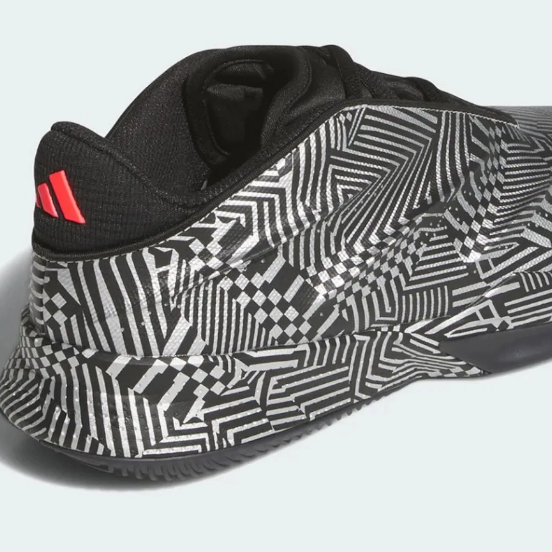The adidas Crazy Energy+ displays a striking black knit upper with red Three Stripes branding on the heel counter, paired with an eye-catching geometric white and black pattern on the midsole and outsole. This rear three-quarter view showcases the shoe's retro-futuristic aesthetic, comfortable knit construction, and innovative LIGHTSTRIKE Pro cushioning technology designed for responsive basketball performance and modern street style.